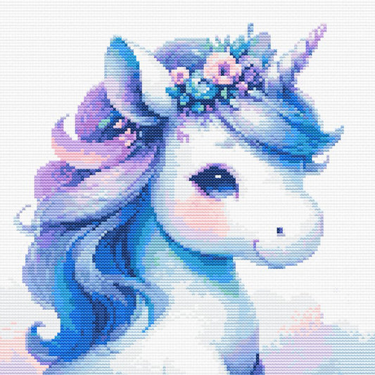 Close-up of Baby Unicorn Cross Stitch Pattern showing the unicorn face, pastel mane, soft blue shading, and visible counted cross stitch texture.