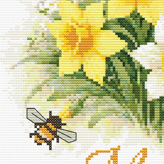 Close-up of March Birth Flower Cross Stitch Pattern showing yellow daffodils, green leaves, bumblebee detail, and visible counted cross stitch texture.