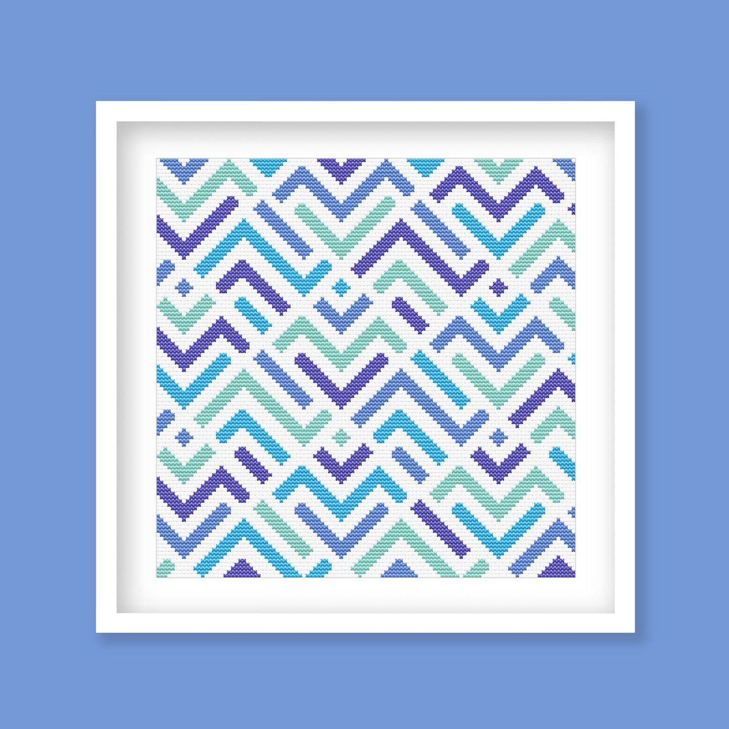 Modern Geometric ZigZag Cross Stitch Pattern displayed in a blue frame with a bright abstract zigzag design for modern wall art.