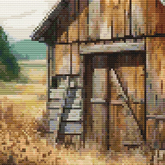 Close up of a rustic barn and green trees in the backgound, the barn door is closed.