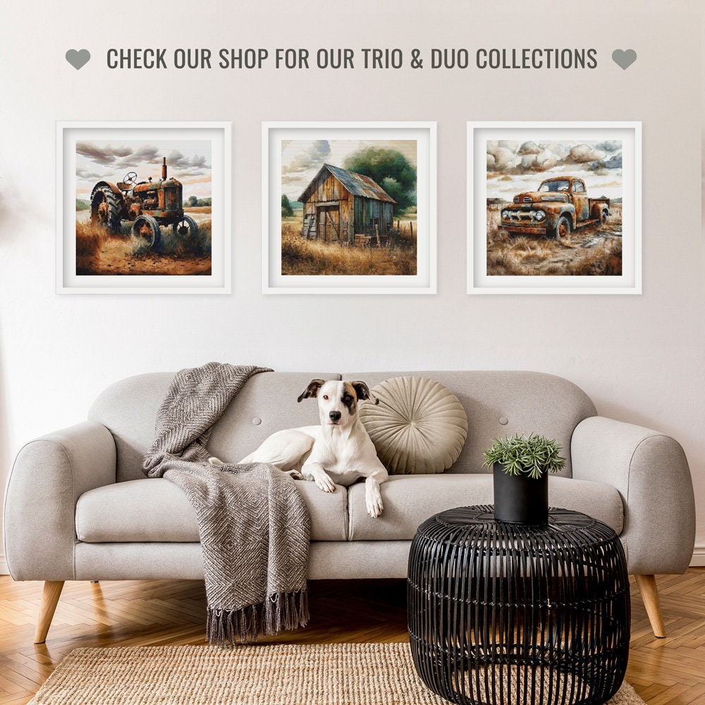 Living room with a gray sofa, dog, and framed pictures of a tractor, barn, and truck.