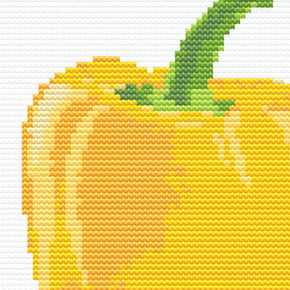 Close up of a cross stitch pattern focusing on a yellow pepper.