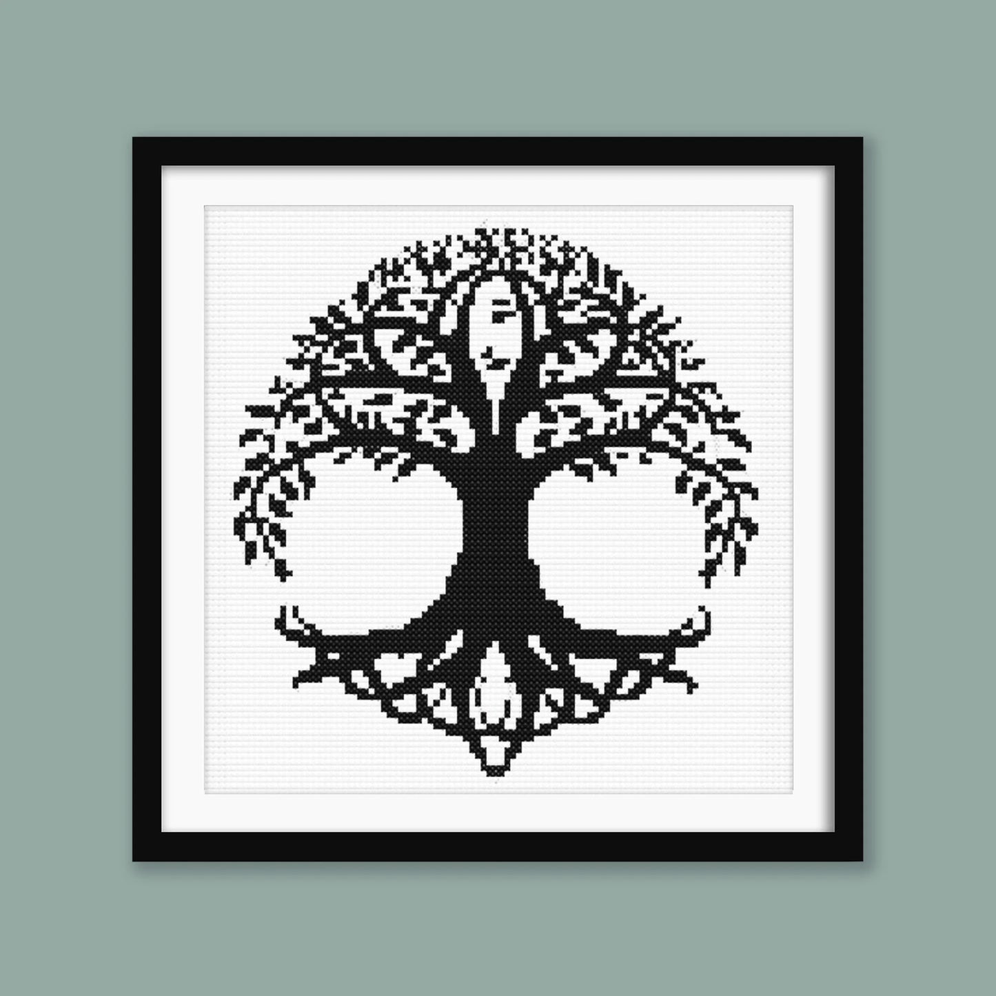 Celtic Tree of Life Cross Stitch Pattern displayed in a sage green frame, styled as symbolic black and white wall art.