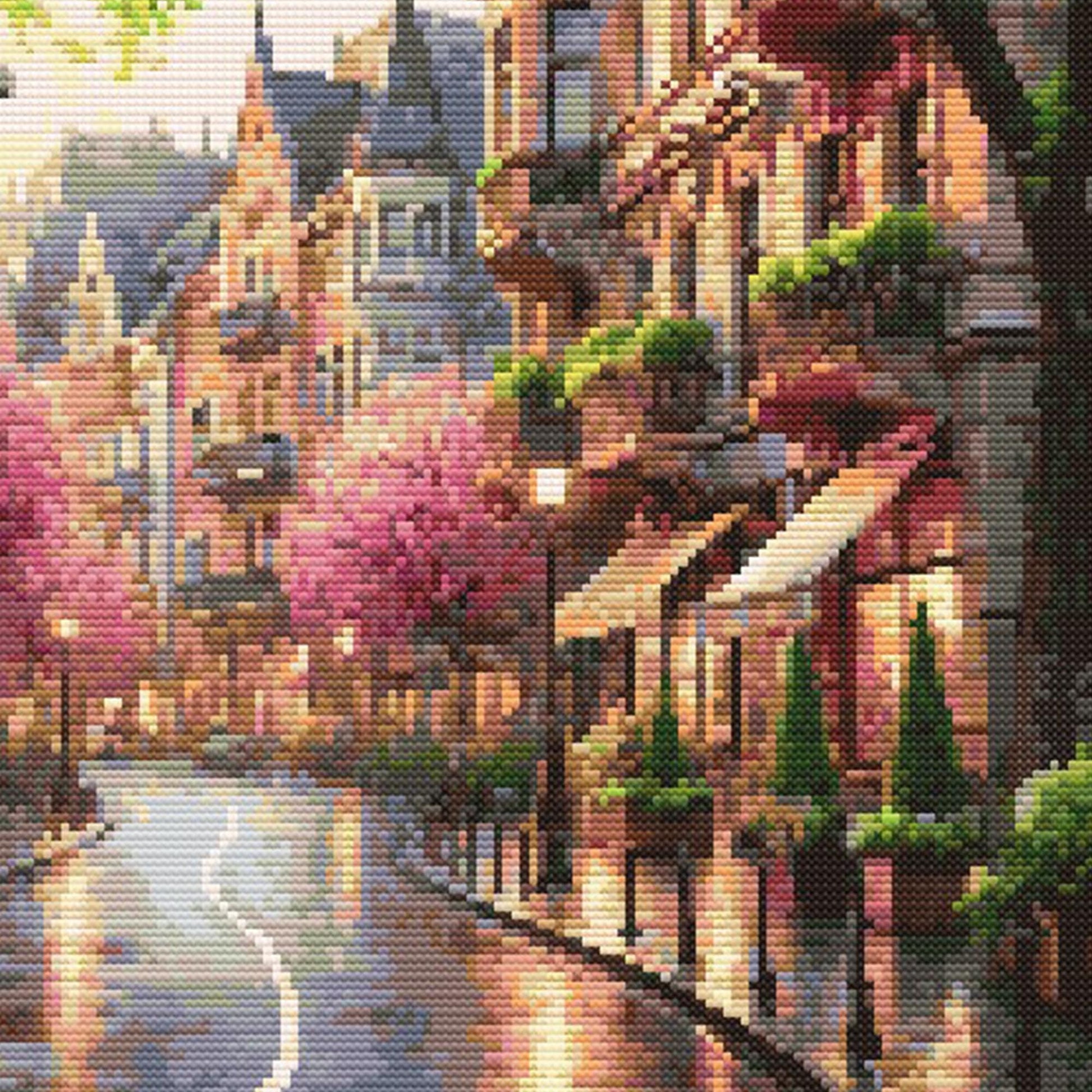 Cityscape Spring Lane Cross Stitch Pattern featuring a charming street scene with pink spring trees, detailed buildings, warm light, and scenic city wall art style.