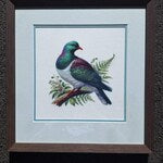 Framed kererū cross stitch finished by a Stitch Junction customer