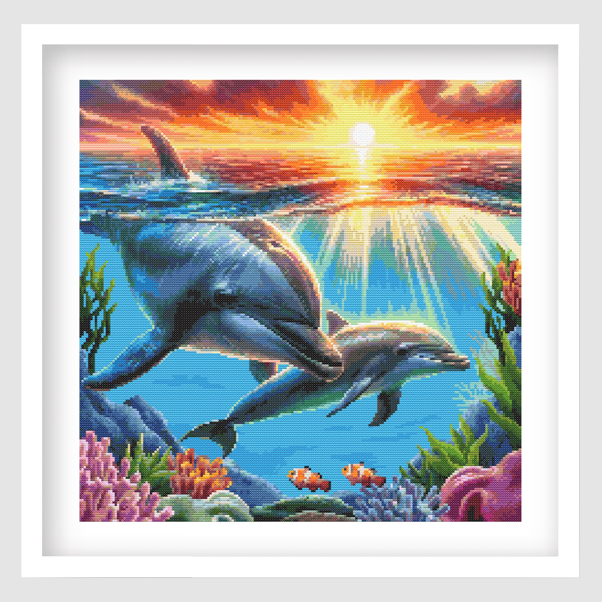 Dolphin cross stitch pattern shown as framed wall art with a bright ocean scene, playful dolphin design, and colourful sea-inspired style