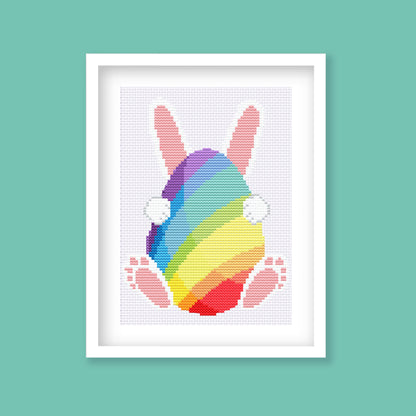 Rainbow Easter bunny digital cross stitch pattern preview on teal background.