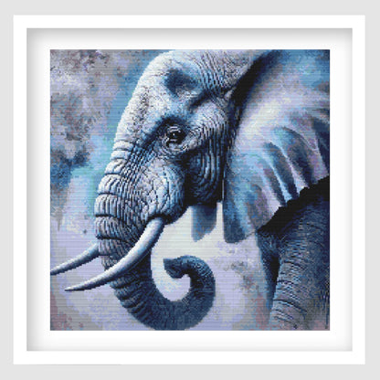 Elephant cross stitch pattern featuring a detailed blue-toned elephant portrait with tusks, curled trunk, textured skin and a soft abstract wildlife background.