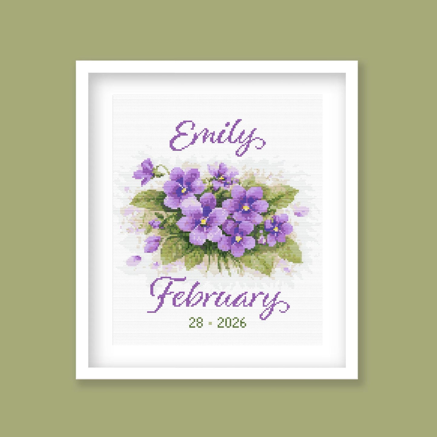 February Birth Flower Cross Stitch Pattern displayed in a sage green frame, featuring personalised violet birth flower artwork.