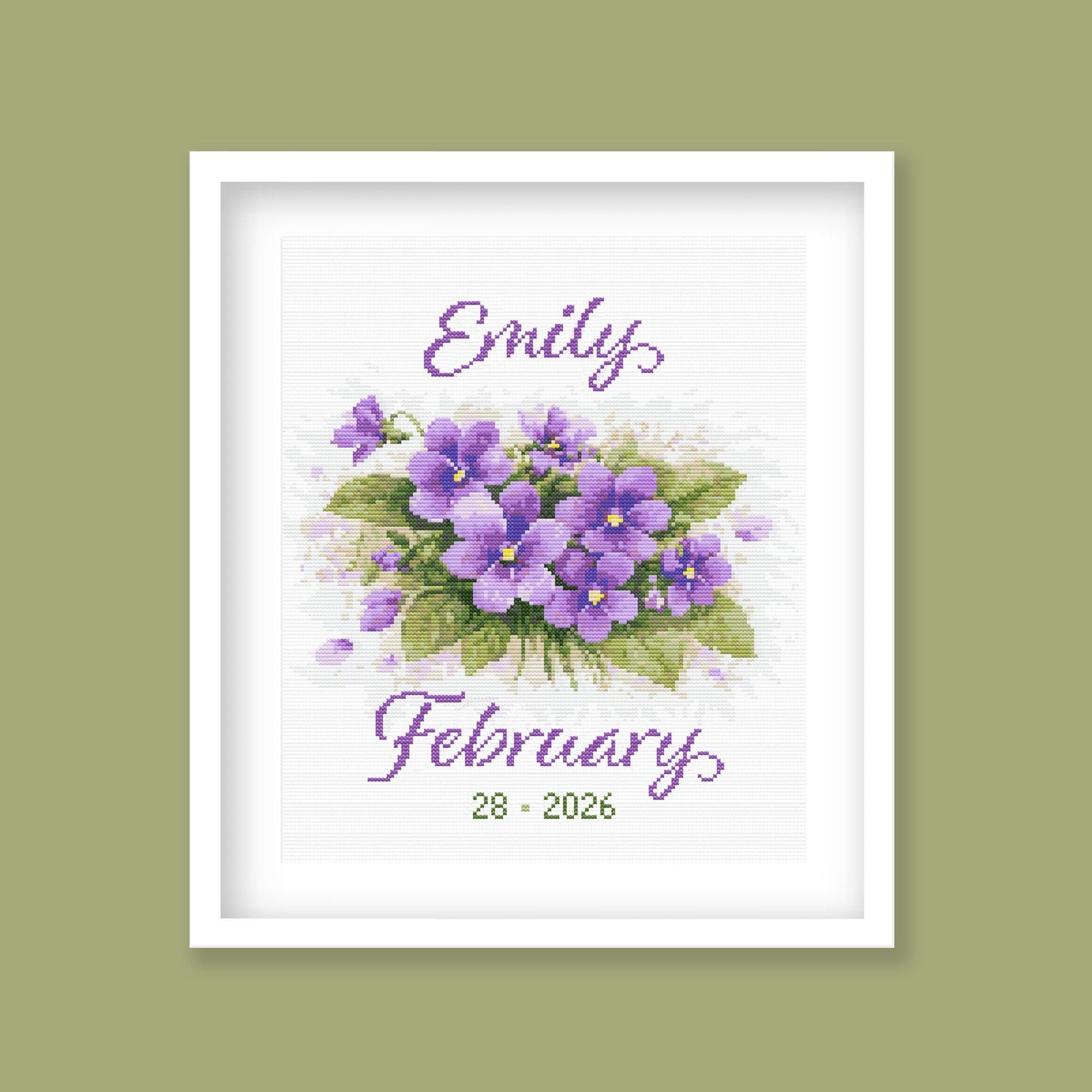 February Birth Flower Cross Stitch Pattern displayed in a sage green frame, featuring personalised violet birth flower artwork.