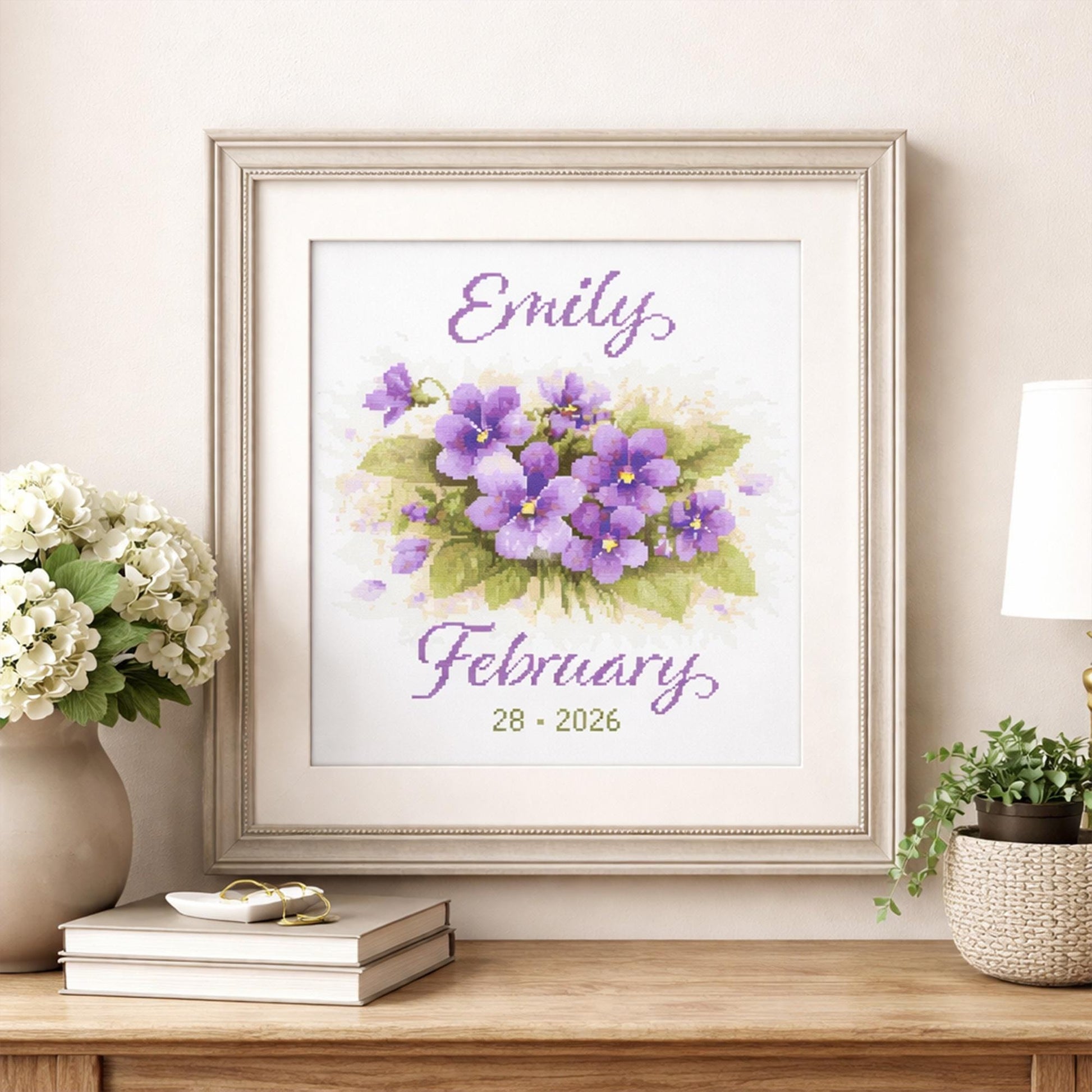 February Birth Flower Cross Stitch Pattern styled as framed nursery wall art with a personalised baby name and birth date.