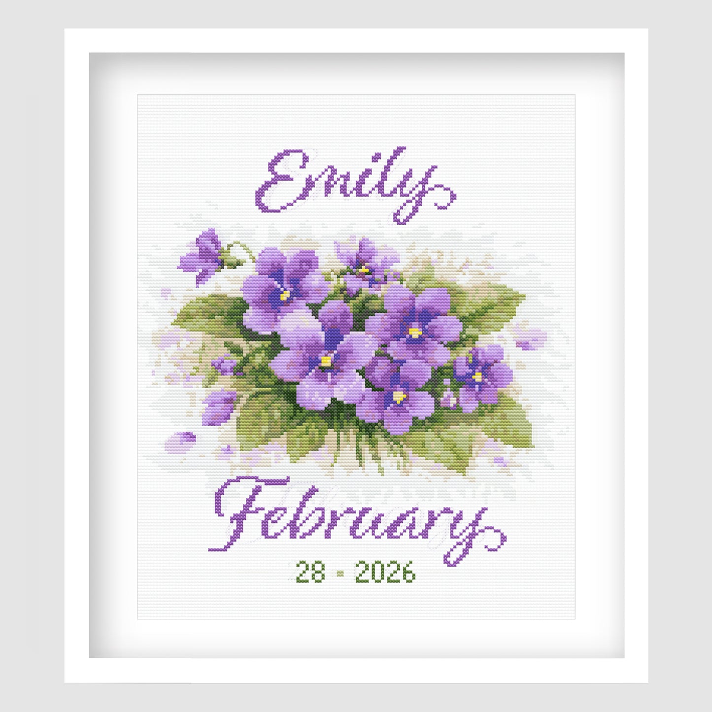 February Birth Flower Cross Stitch Pattern displayed in a white frame, featuring purple violets with a personalised baby name and birth date.