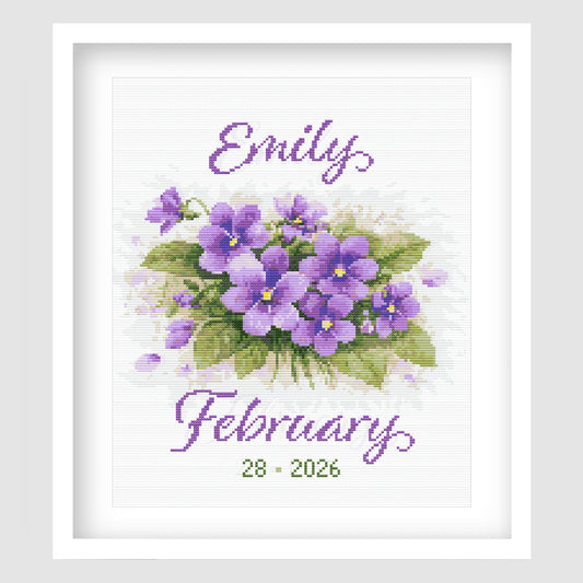 February Birth Flower Cross Stitch Pattern displayed in a white frame, featuring purple violets with a personalised baby name and birth date.