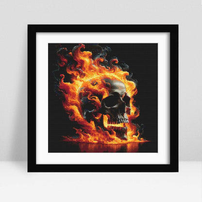 Flaming Skull Cross Stitch Pattern displayed in a black frame, styled as bold gothic wall art with vivid flames and a dark background.