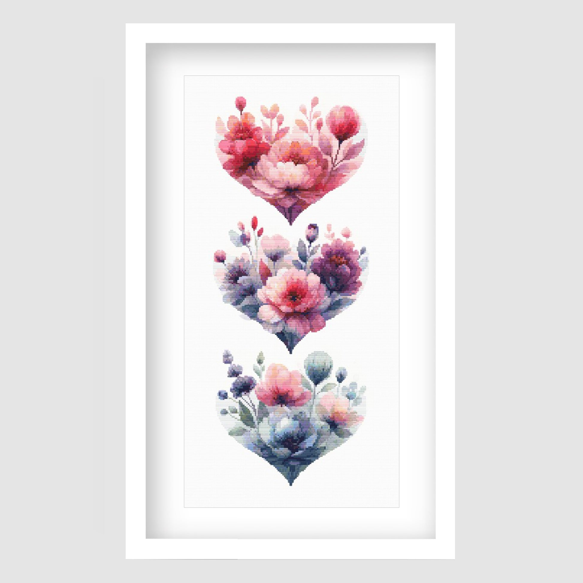 Floral hearts cross stitch pattern featuring three stacked heart-shaped flower arrangements in soft pink, purple and blue tones, designed as a romantic botanical digital PDF chart.