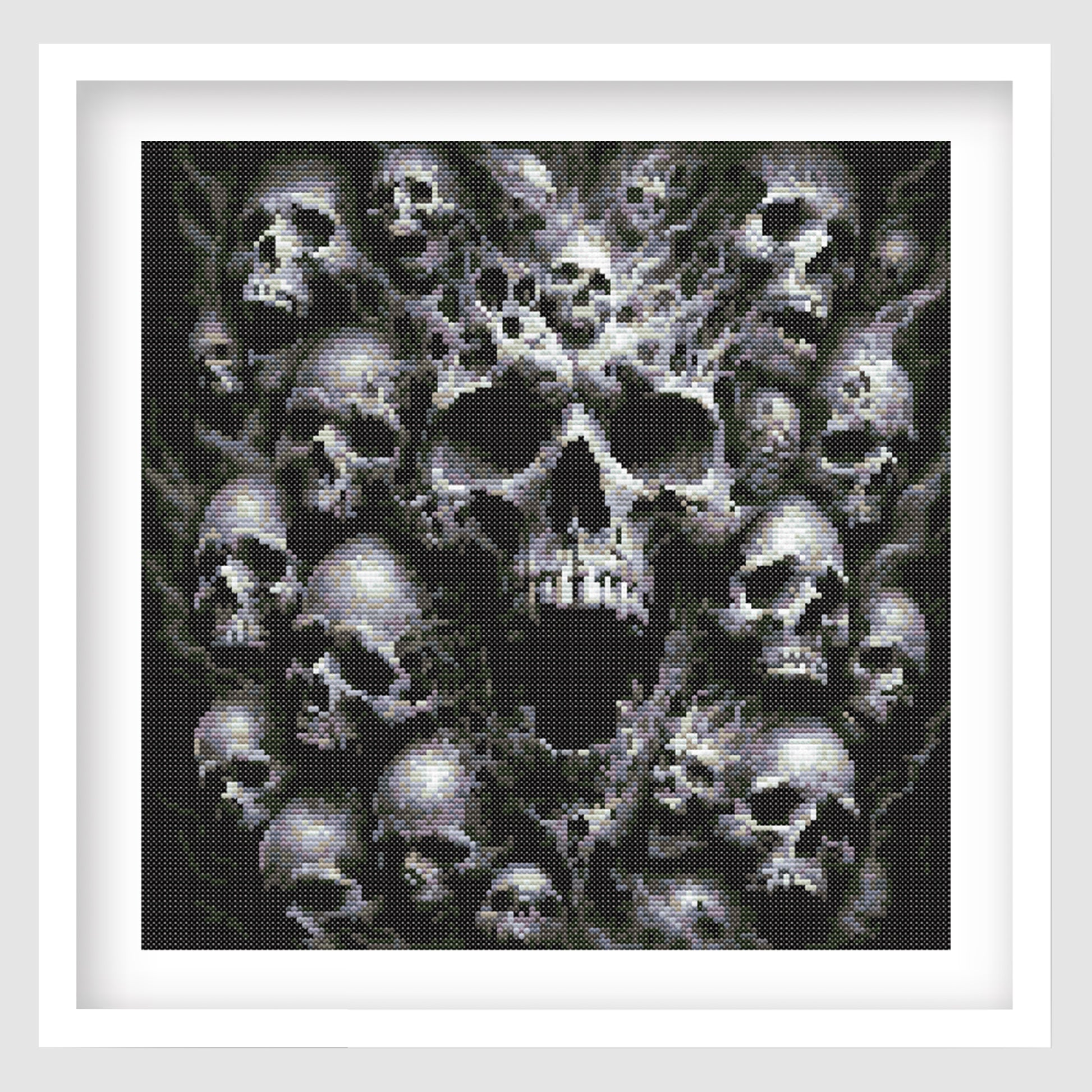 Framed artwork of a central skull surrounded by smaller skulls on a white background