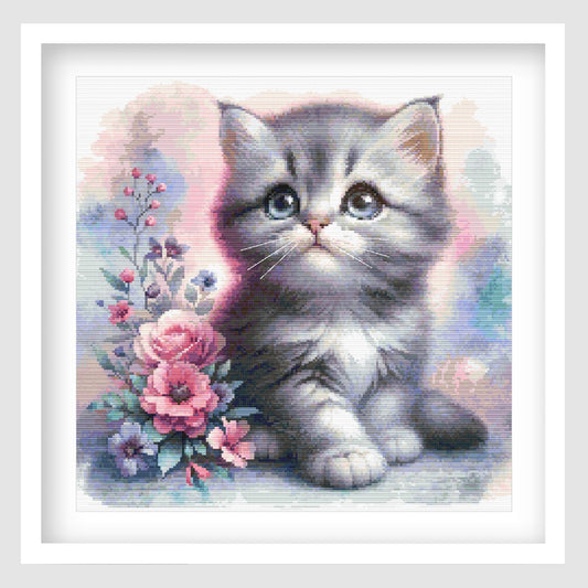 Cute kitten cross stitch pattern featuring a grey and white kitten with blue eyes, soft pastel background and pink floral details.