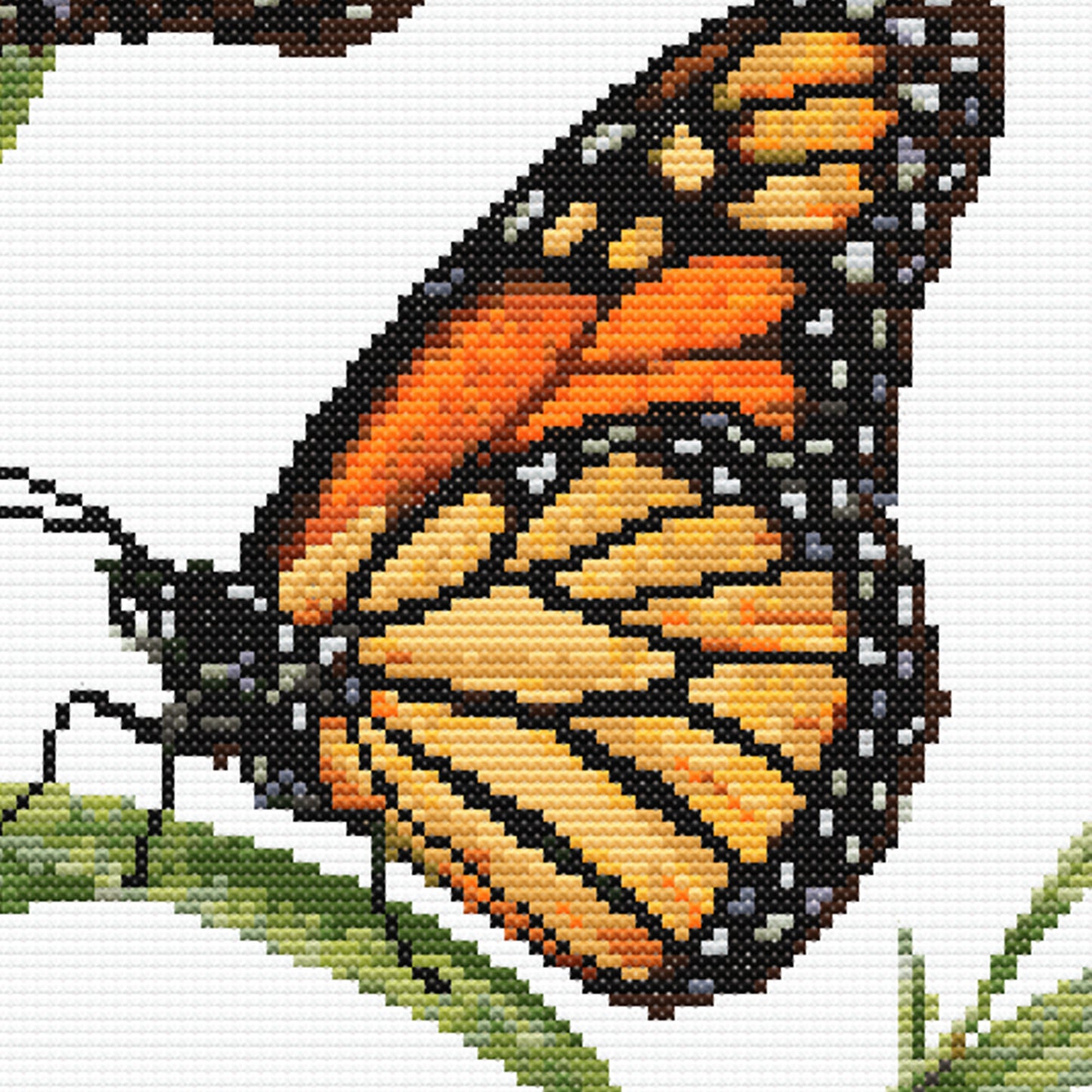 Monarch Butterfly Cross Stitch Pattern detail highlighting the butterfly wing pattern, warm orange tones and fine black edging.