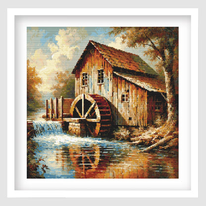 Rustic watermill cross stitch pattern featuring a countryside waterwheel scene, shown as framed wall art.