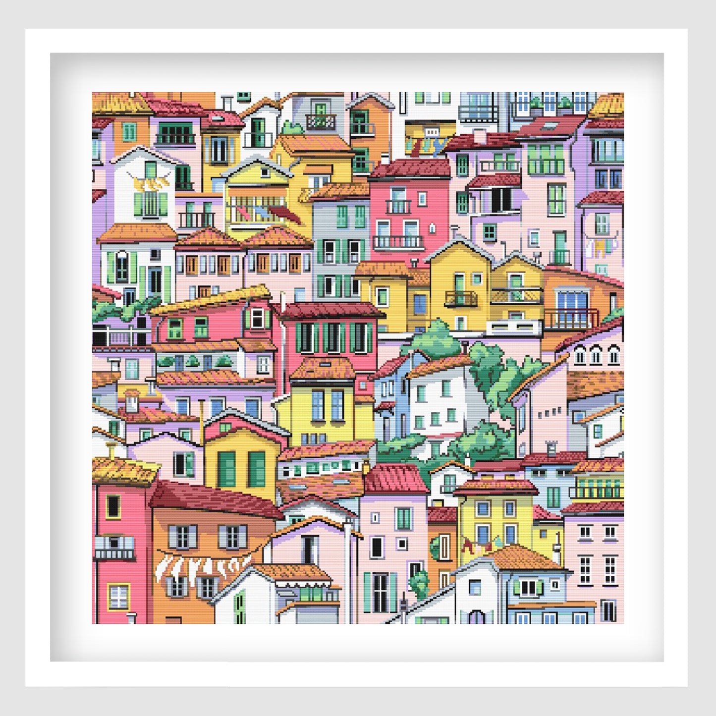 Colourful village cross stitch pattern featuring a dense hillside scene of bright pastel houses, tiled rooftops, balconies and detailed architectural windows.