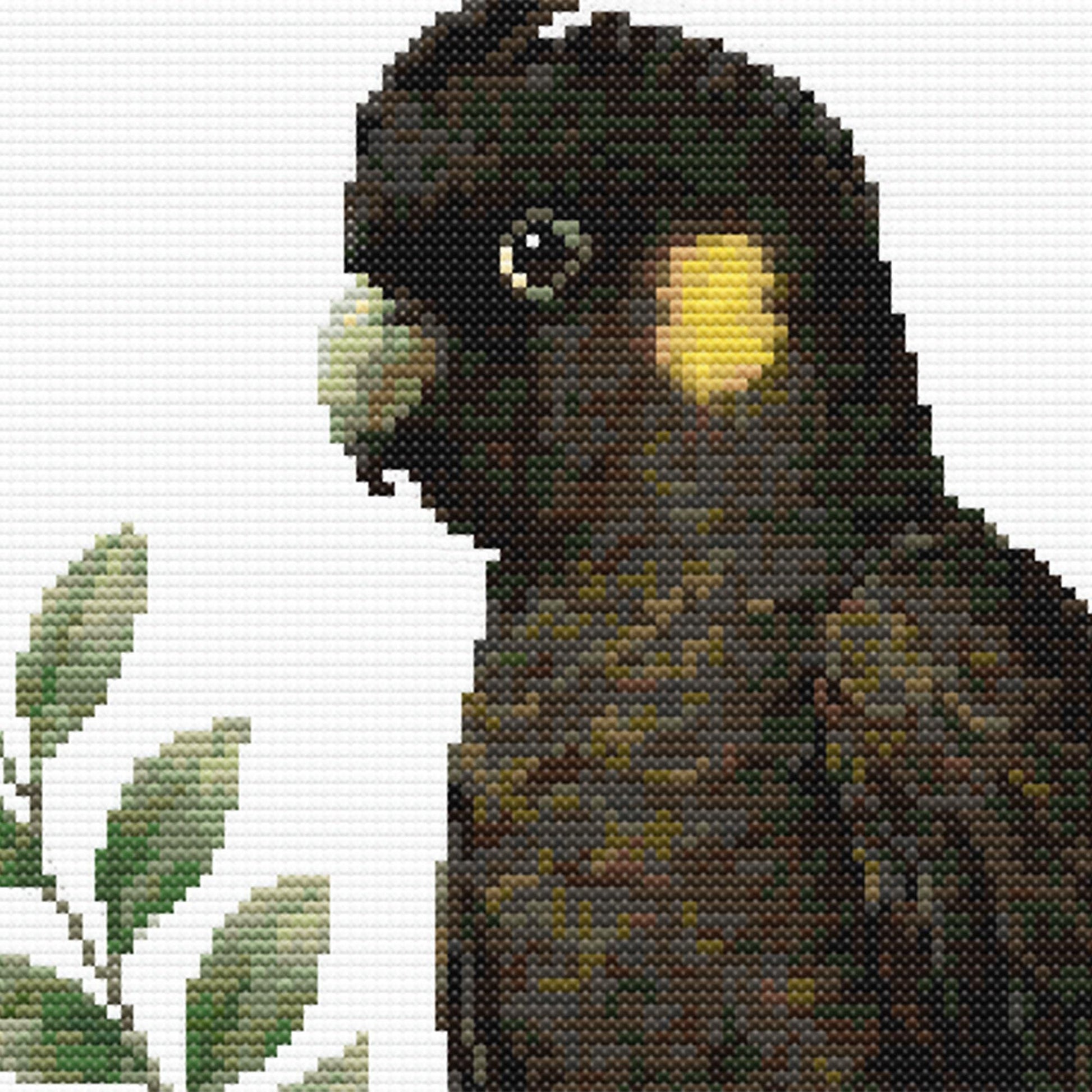 Yellow-Tailed Black Cockatoo Cross Stitch Pattern close-up highlighting the bird's distinctive dark feathers, yellow cheek patch and realistic wildlife details.