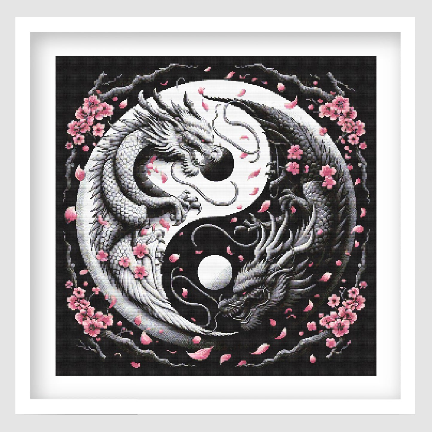 Yin yang dragon cross stitch pattern featuring two detailed black and white dragons curled around a moon-style symbol, with pink cherry blossoms and falling petals on a dark background.