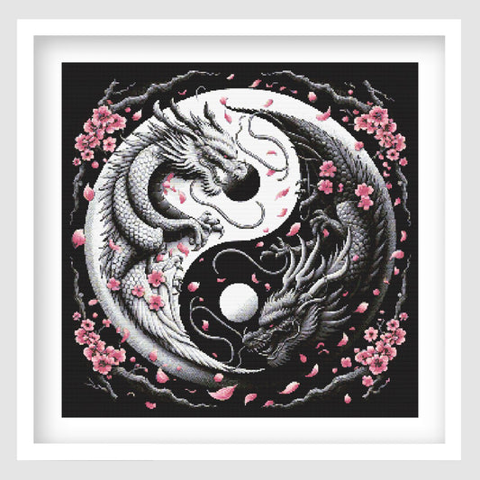 Yin yang dragon cross stitch pattern featuring two detailed black and white dragons curled around a moon-style symbol, with pink cherry blossoms and falling petals on a dark background.