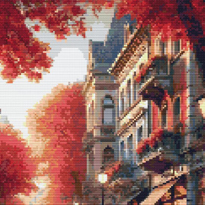 Close-up of Autumn Cityscape Cross Stitch Pattern showing warm sunlight, autumn trees, urban architecture, and rich seasonal colour.