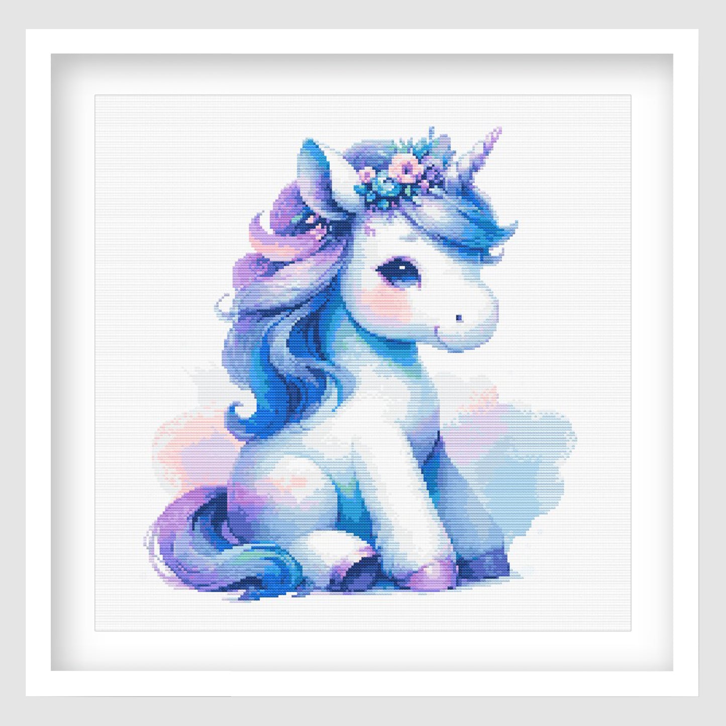 Baby Unicorn Cross Stitch Pattern displayed as framed wall art with a soft blue and purple unicorn design for nursery or kids room decor.