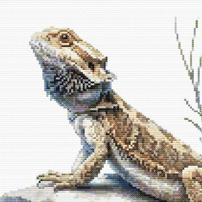 Close-up of Bearded Dragon Lizard Cross Stitch Pattern showing the lizard head, textured scales, claws, and visible counted cross stitch texture.