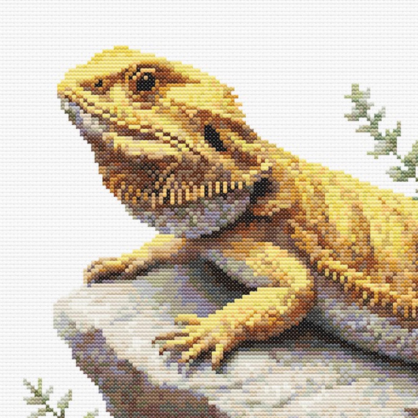 Cross-stitched lizard on a rock with a light background