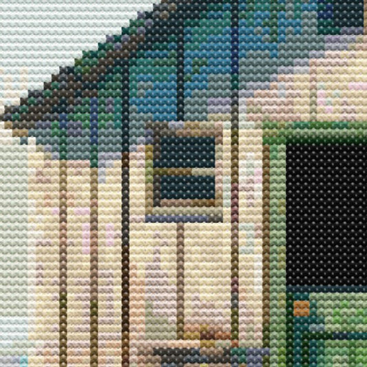 Close-up of Boat Shed Cross Stitch Pattern showing the weathered shed wall, open doorway, timber texture, and coastal stitching detail.