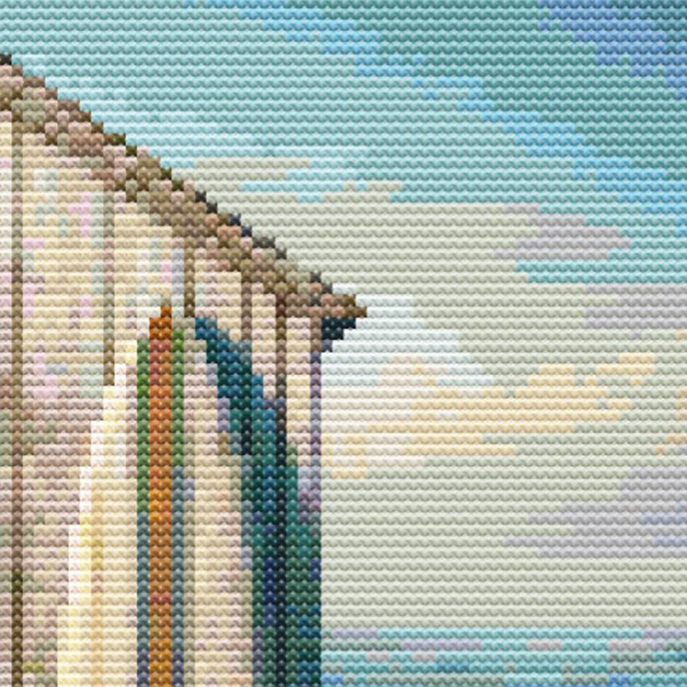 Close-up of Boat Shed Cross Stitch Pattern showing the side of the boat shed, soft blue sky, and coastal landscape detail.