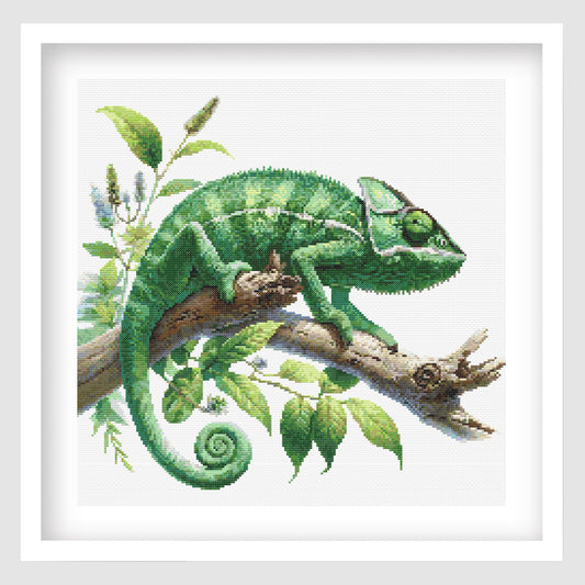 Cross-stitched chameleon on a branch with leaves