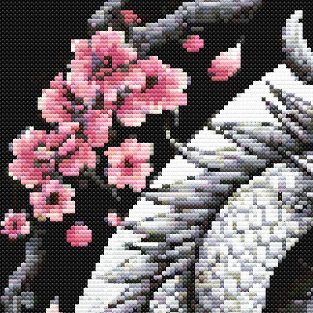 Close-up of Chinese Dragon Cross Stitch Pattern showing cherry blossom branches, dragon scales, black background, and visible stitch texture.
