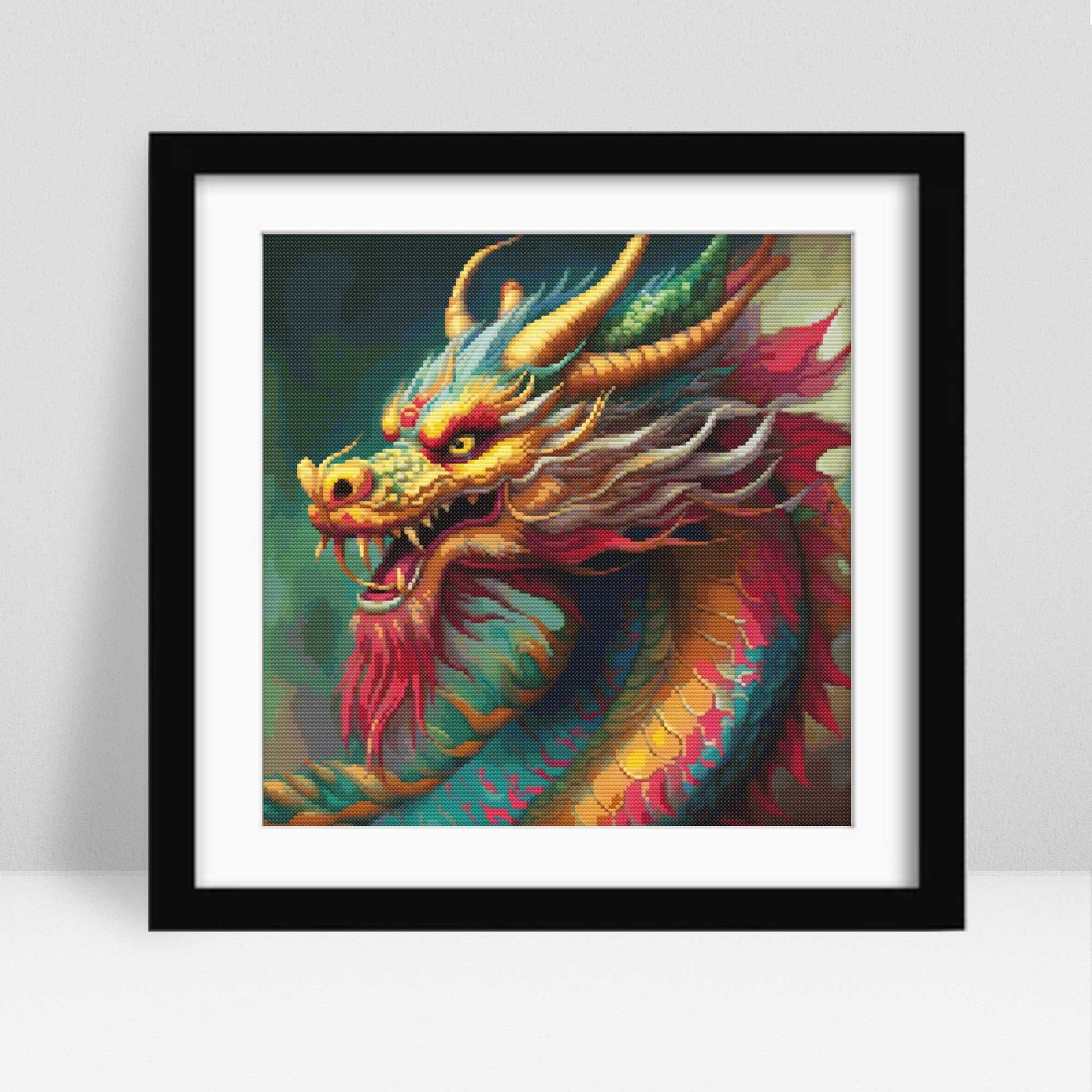 Framed artwork of a colorful dragon on a white background. Chinese dragon cross stitchframed.