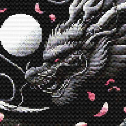 Close-up of Chinese Dragon Cross Stitch Pattern featuring the yin-yang circle, dragon scales, moon detail, and pink blossom accents.