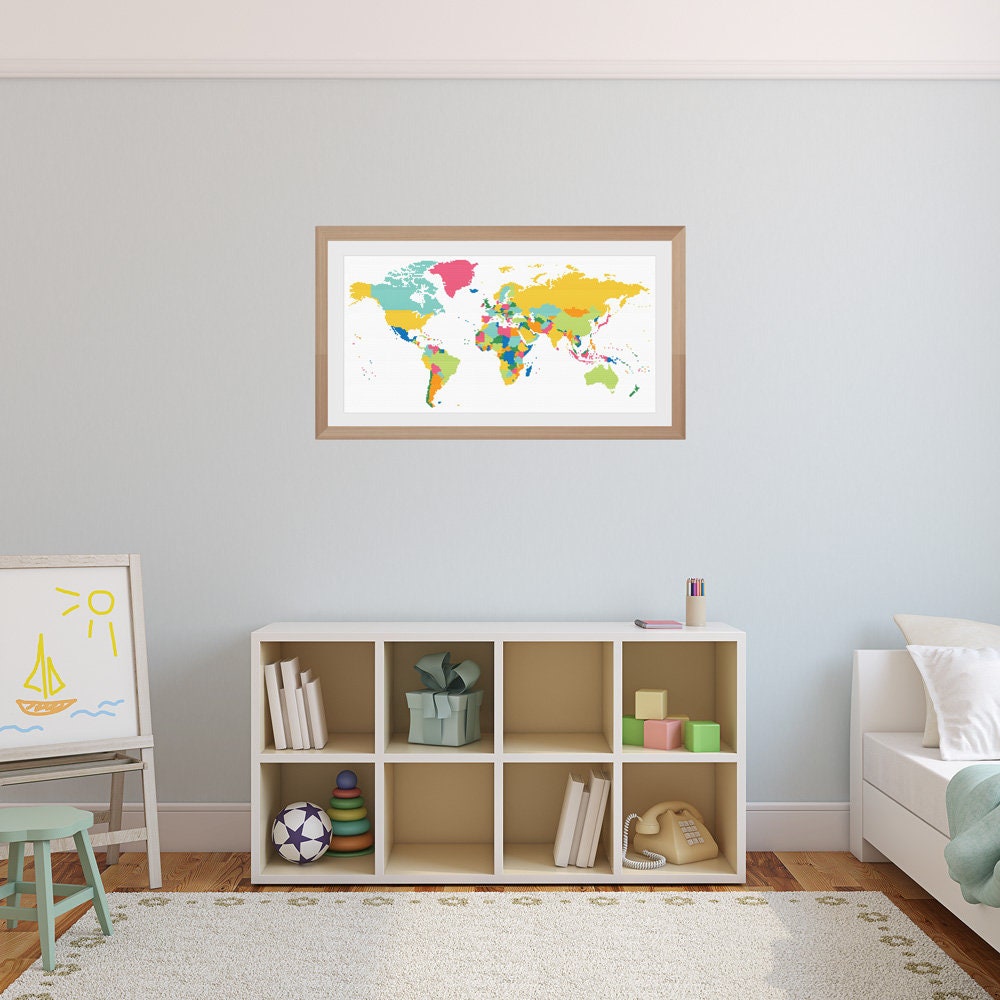 Colourful World Map Cross Stitch Pattern shown in a nursery or playroom preview with bright travel-inspired wall art and soft room styling.