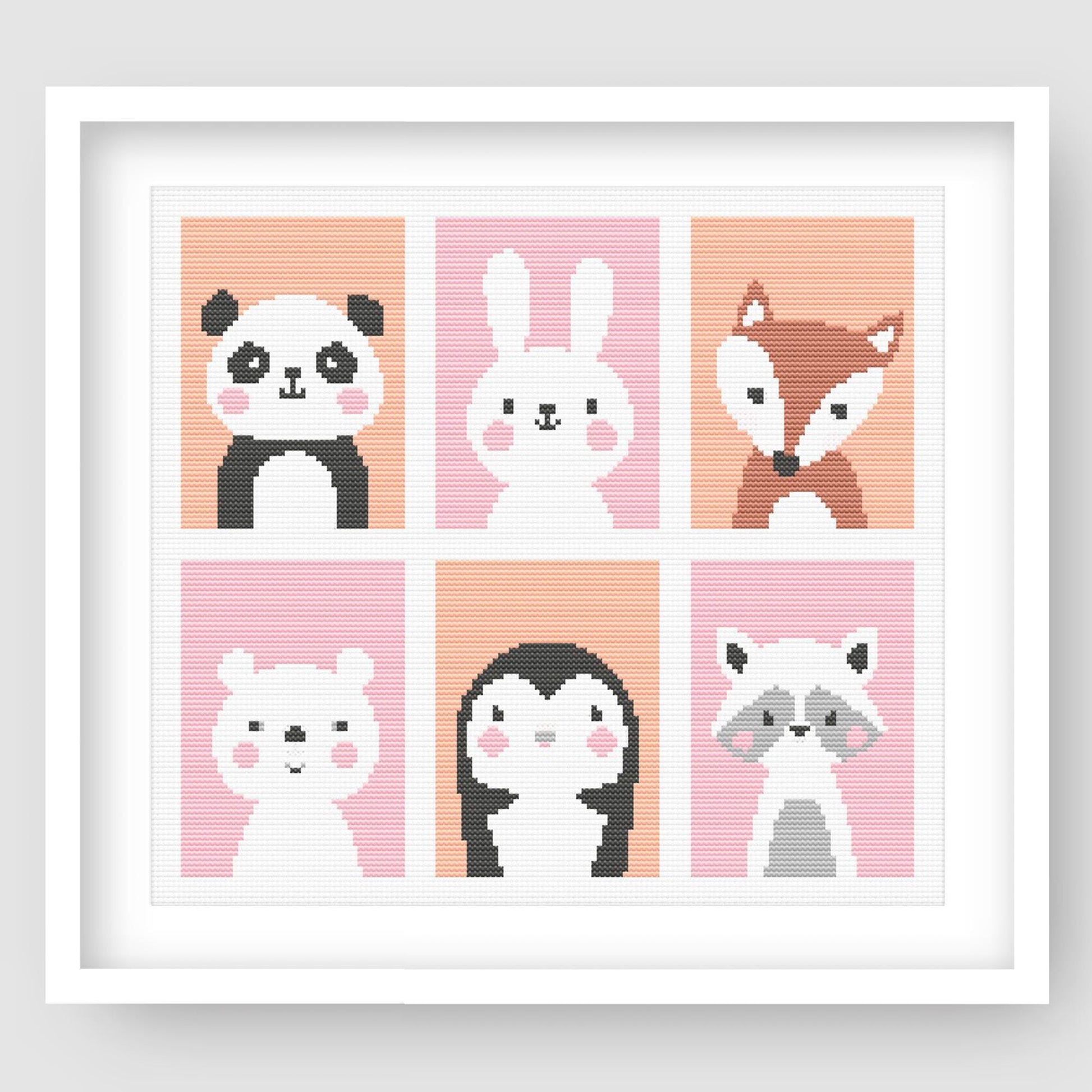Cute Nursery Animal Cross Stitch Pattern Set displayed as framed wall art with six animal designs in soft pink panels for nursery or kids room decor.