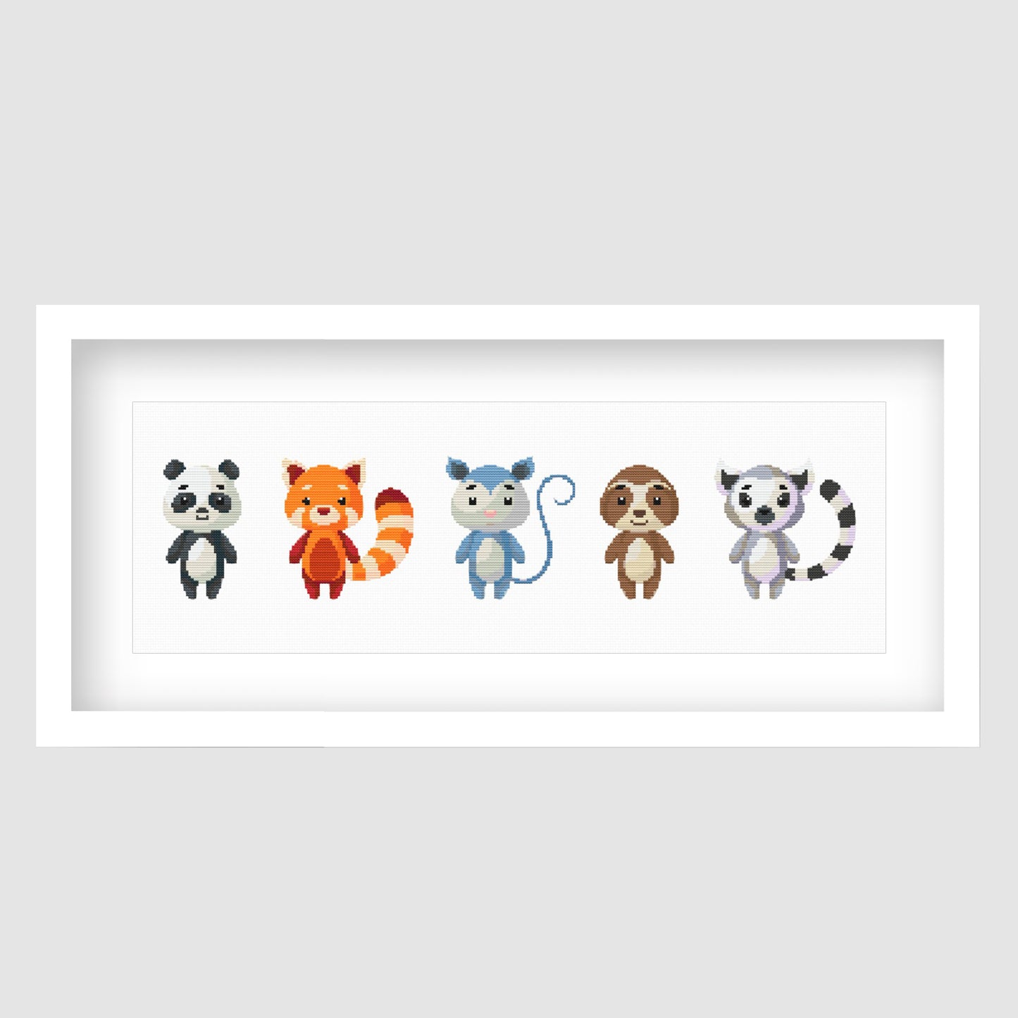 Cute Woodland Animal Cross Stitch Pattern displayed as framed wall art with a row of colourful forest animals for nursery or kids room decor.