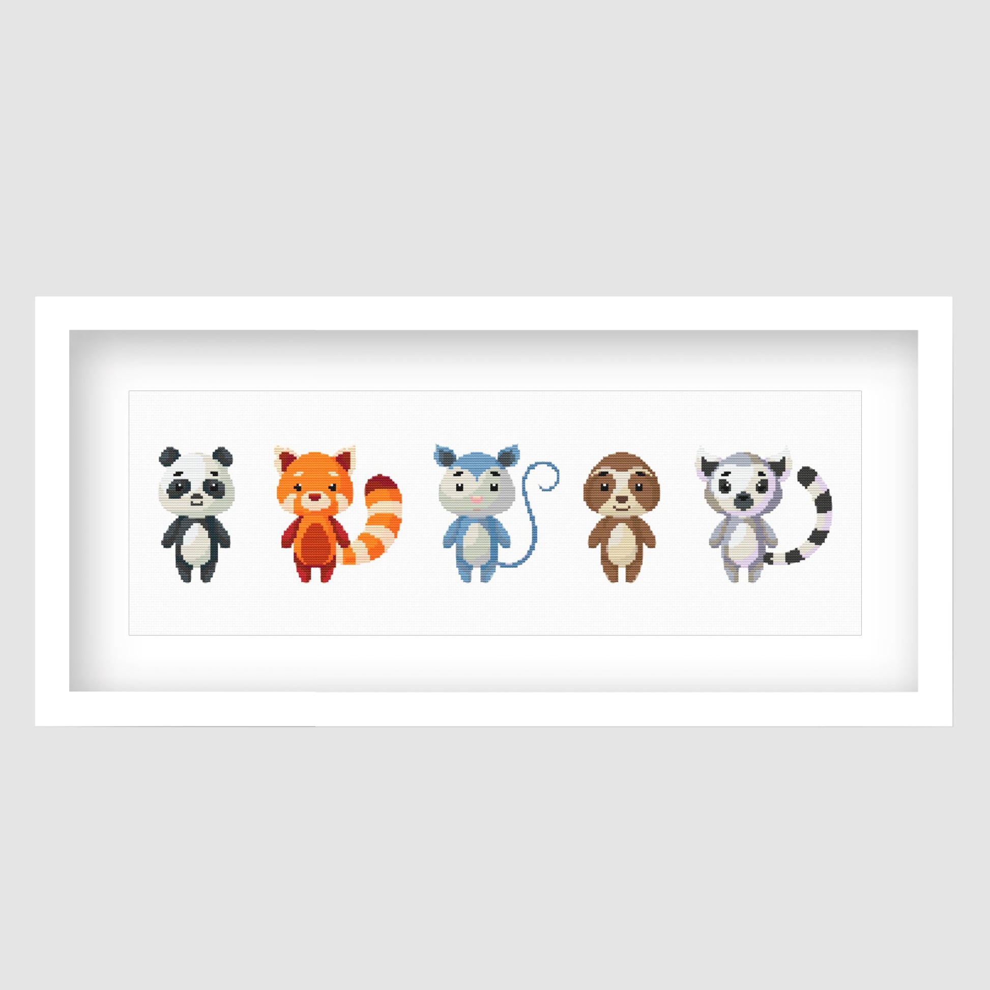 Cute Woodland Animal Cross Stitch Pattern displayed as framed wall art with a row of colourful forest animals for nursery or kids room decor.