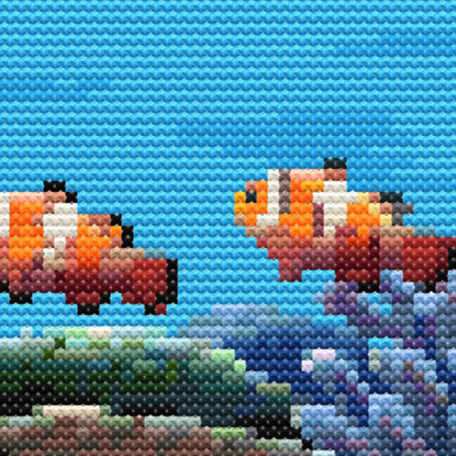 cross stitch pattern close up of detailed stitching and two orange clown fish.