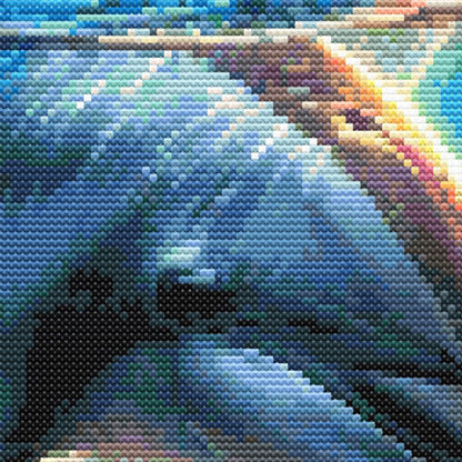 Close-up of dolphin cross stitch pattern showing detailed stitching, blue ocean colours, and playful marine animal design.