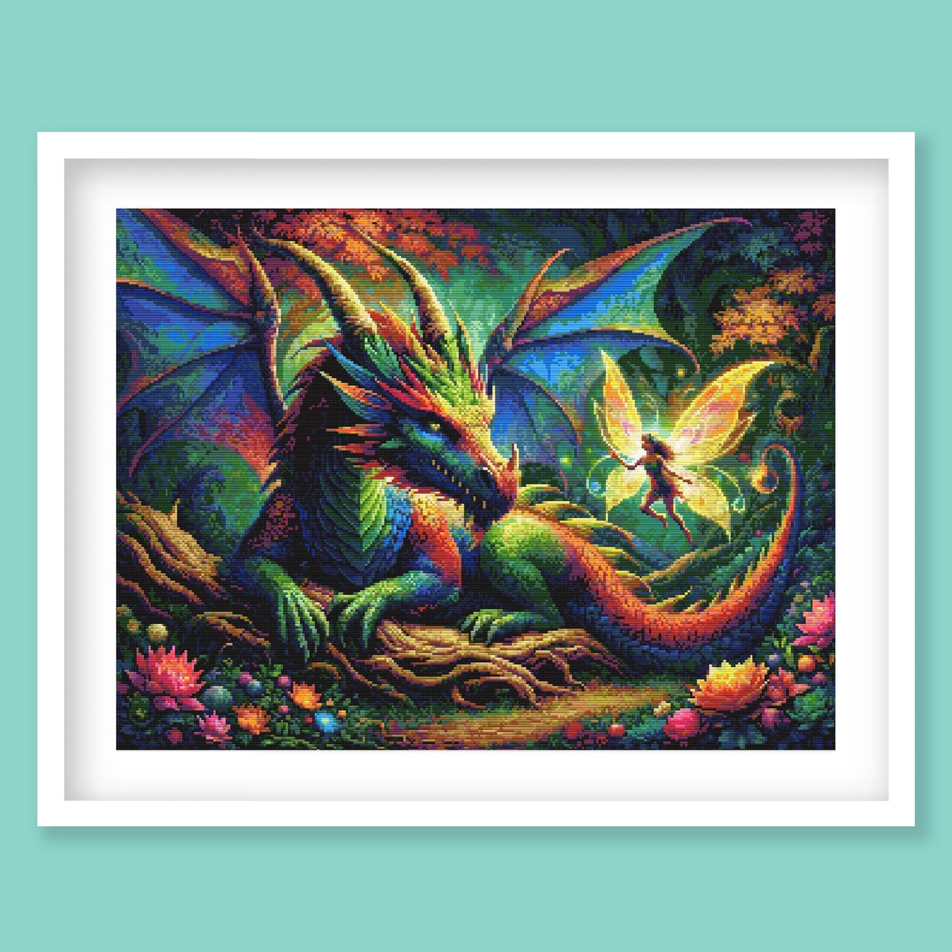 Dragon and Fairy Cross Stitch Pattern displayed in a blue frame as colourful fantasy wall art with a dragon, fairy glow, and enchanted forest scene.
