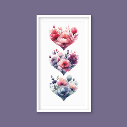 Floral Heart Cross Stitch Pattern Set displayed as framed wall art with stacked heart designs, soft pink flowers, blue leaves, and romantic botanical detail.