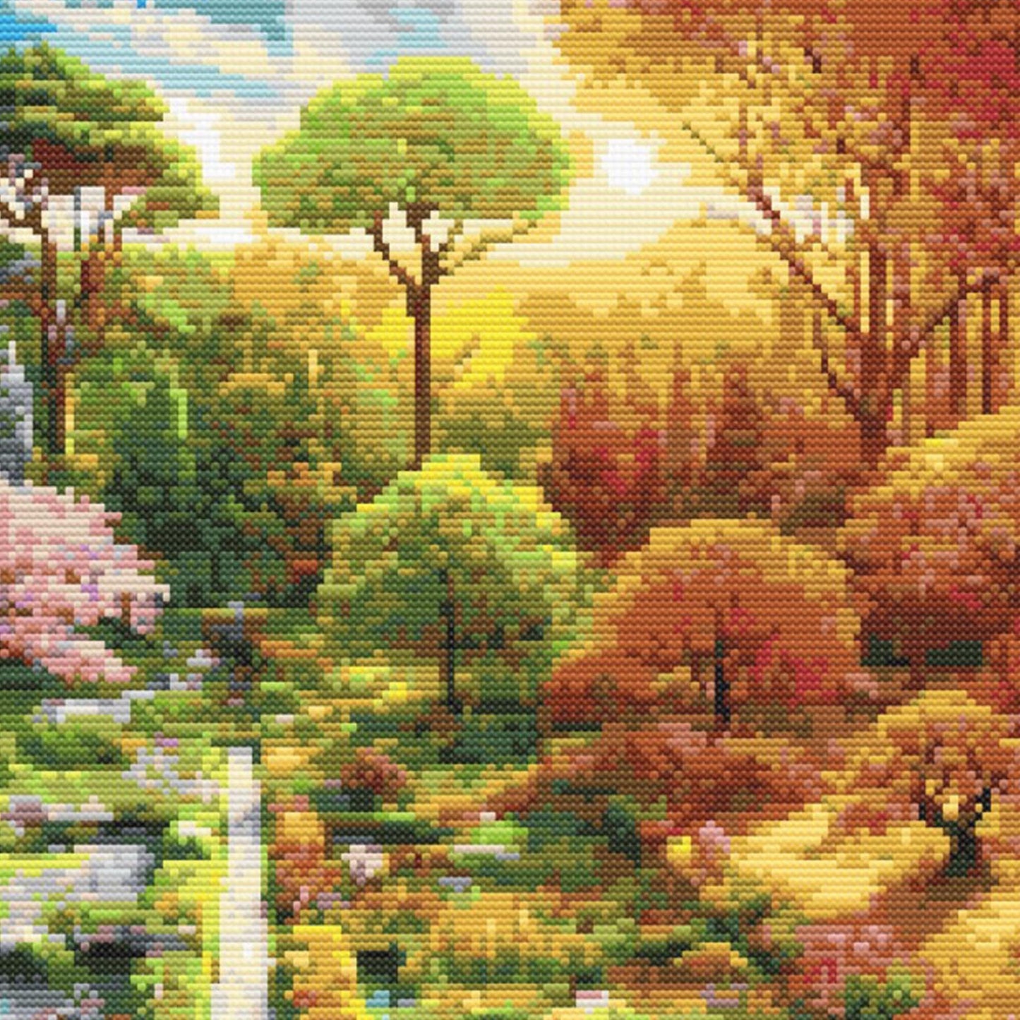Close-up of Four Seasons Garden Cross Stitch Pattern showing golden autumn trees, warm sunlight, garden paths, and rich seasonal colour.