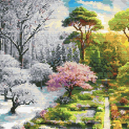 Close-up of Four Seasons Garden Cross Stitch Pattern showing winter trees, soft snow tones, garden paths, and visible counted cross stitch texture.