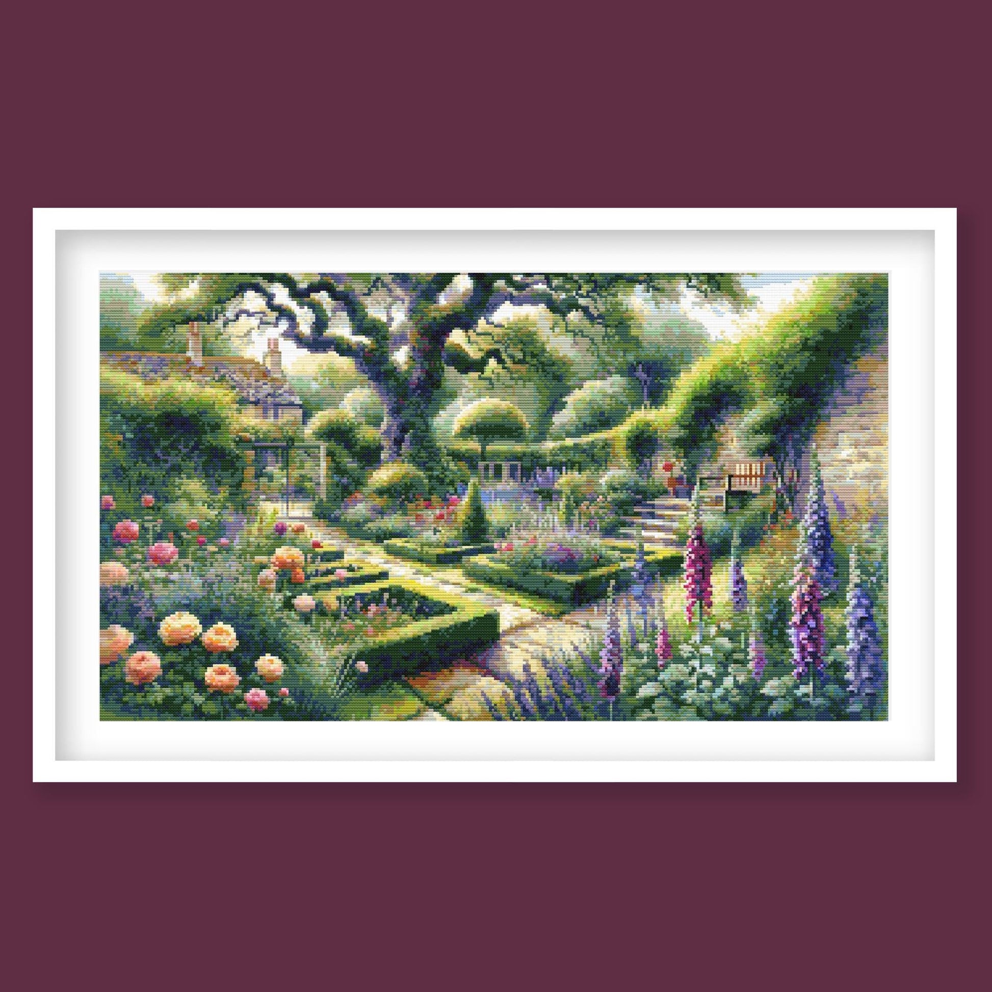 Garden Landscape Cross Stitch Pattern displayed in a white frame on a burgundy background, featuring a formal garden path, flowering borders, clipped hedges, and large trees.