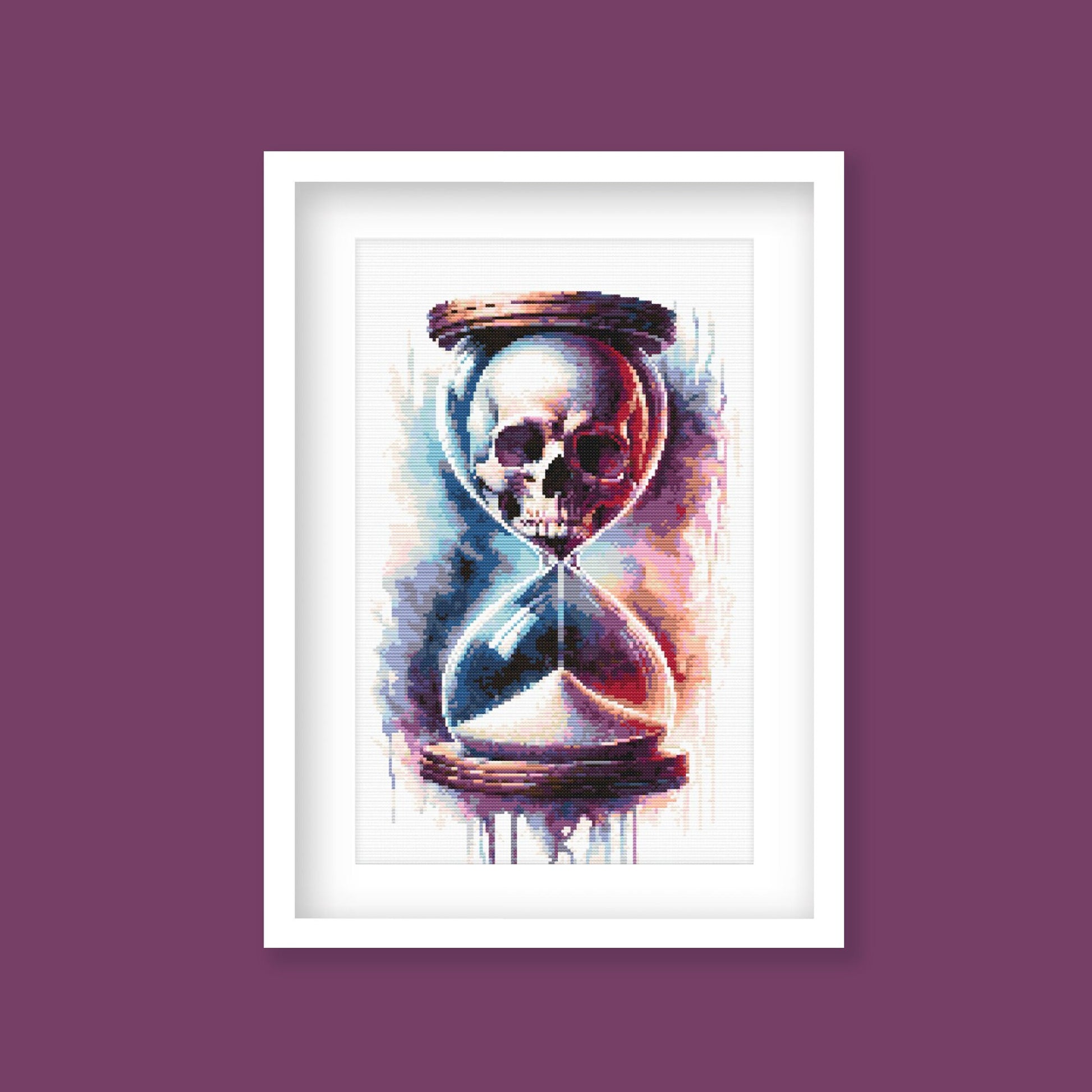 Gothic Hourglass Skull Cross Stitch Pattern displayed in a dark frame as dramatic gothic wall art with skull and hourglass detail.