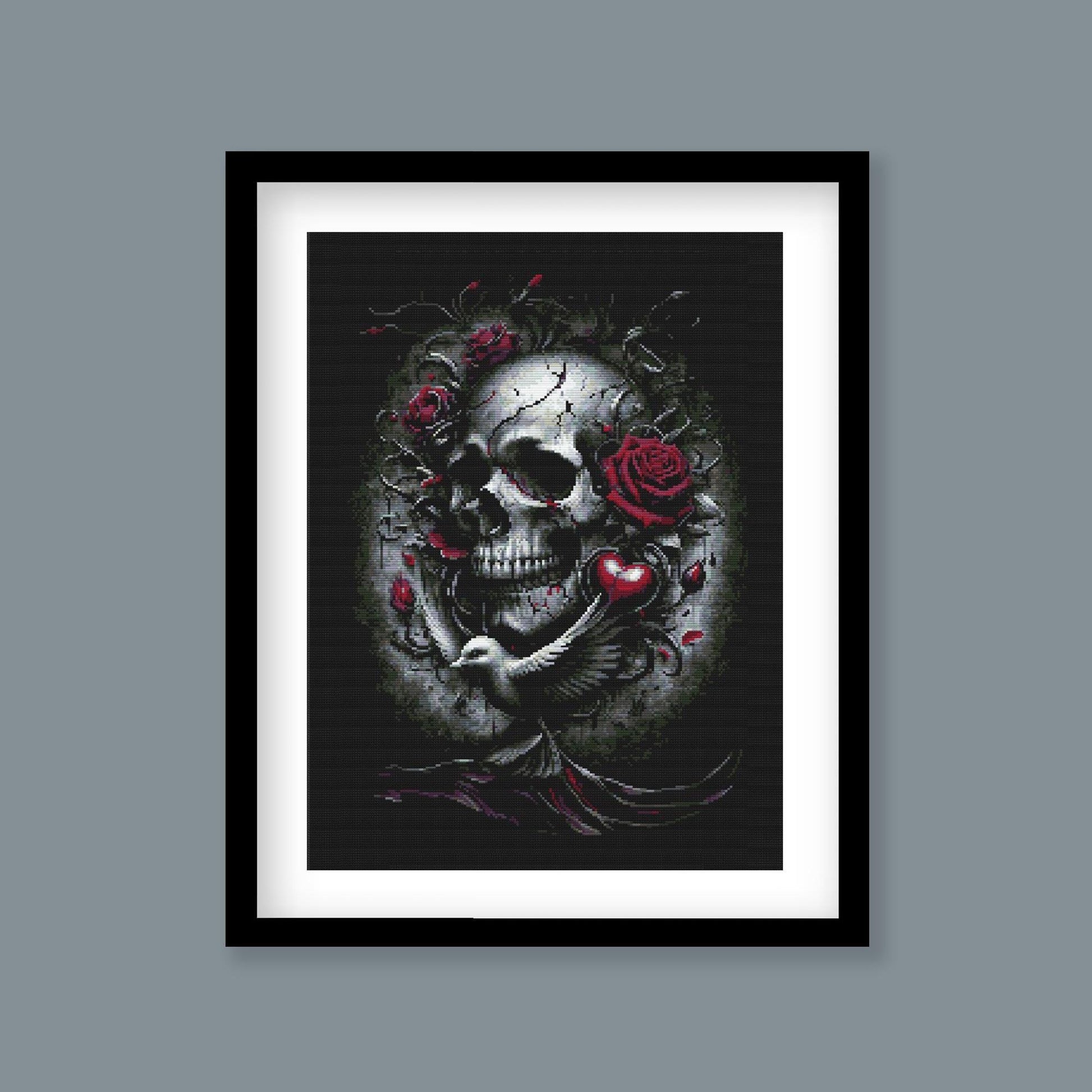 Gothic Skull and Roses Cross Stitch Pattern displayed as framed wall art with a dark skull, red rose detail, and dramatic gothic styling.